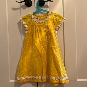Sweeest yellow dress with daisy detailing.